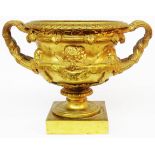 A 19th Century gilt cast metal urn of classical form with two handles and frieze decoration