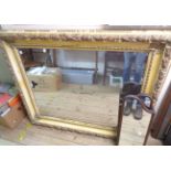 A large old ornate framed bevelled oblong wall mirror with decorative moulded border - some gesso