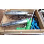 A drawer containing a quantity of assorted tools including two vintage grease guns, auger bits,
