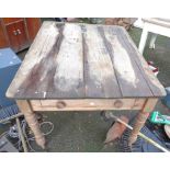 A 1.3m old pine farmhouse kitchen table with rustic plank top and single frieze drawer, set on