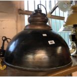 A large industrial style hanging ceiling lamp with metal dome and wooden fitting