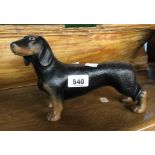 A modern painted cast iron doorstop in the form of a dachshund
