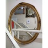 A modern gilt framed bevelled oval wall mirror with moulded border
