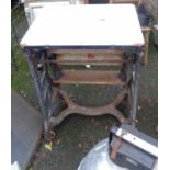 An old metamorphic table mangle with enamelled top surface, set on a cast iron base - by Gamages