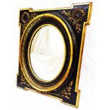 An antique ebonised and parcel gilt framed wall mirror with stepped corners, oval plate and