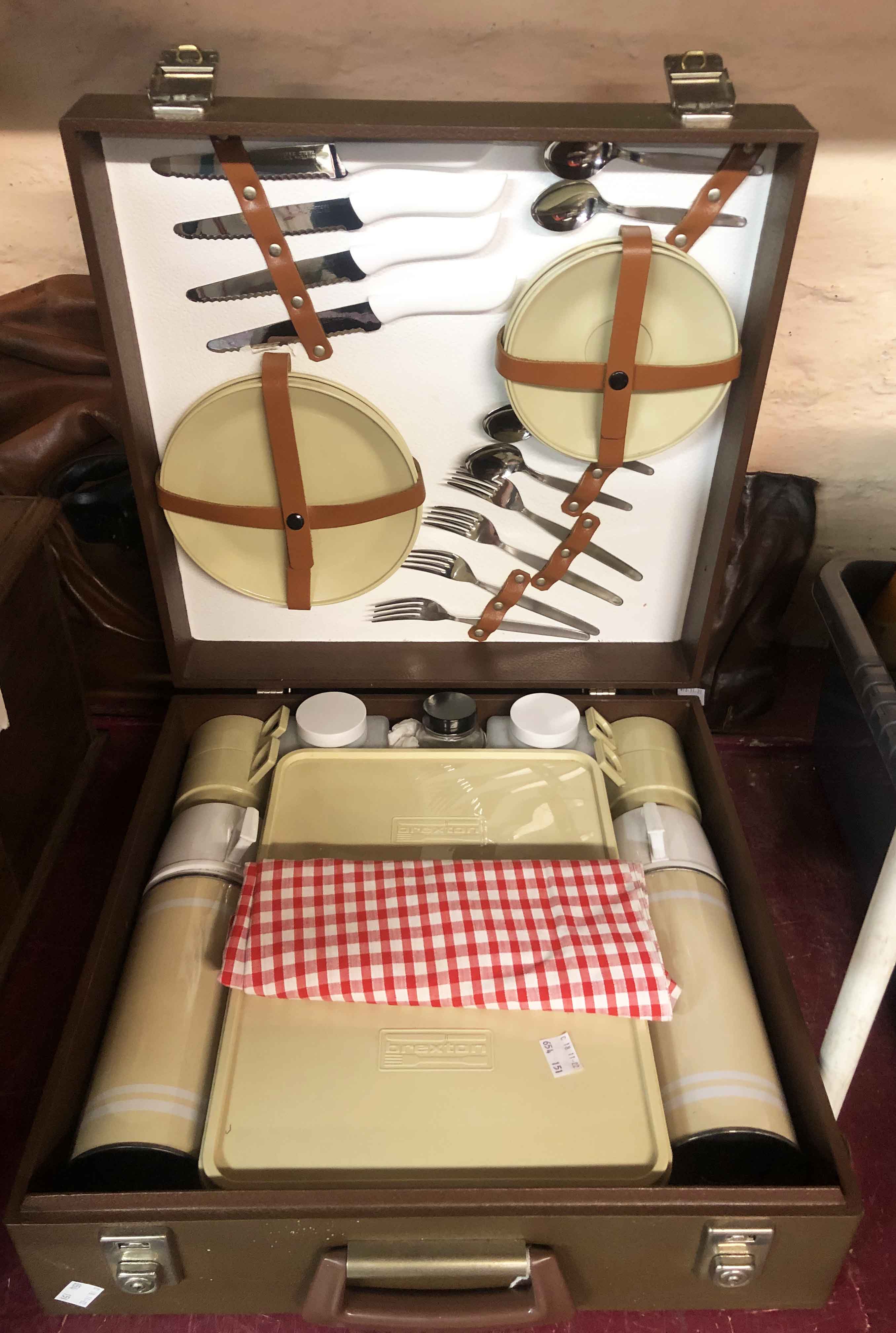 A vintage Brexton picnic set in leatherette covered case containing two vacuum flasks, four cups and