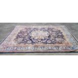 A hand made wool Persian pattern carpet with profuse floral scroll decoration within a decorative