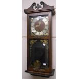 A 20th Century stained wood cased wall clock with visible pendulum and thirty one day gong
