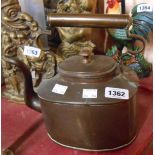 A Victorian copper kettle of oval form with fancy scroll handle and cast lion's head finials