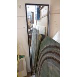 An ebonised framed narrow oblong wall mirror