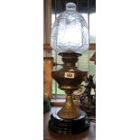 A late 19th Century brass oil lamp with Art Nouveau moulding to pedestal, glass chimney and