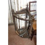 An old oak corner stick stand with carved decoration to top, set on bobbin turned supports, with