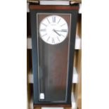 A Seiko QXH062K polished wood cased wall clock with visible pendulum, glazed door and quartz