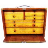 A 46cm vintage mixed wood engineer's tool chest with and array of graduated drawers enclosed by a