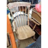 A stripped wood high stick back Windsor elbow chair with moulded solid elm seat, set on ring