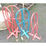 Four painted metal saddle stretchers