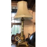 An old onyx table lamp of column form with ormolu and champleve enamel fittings