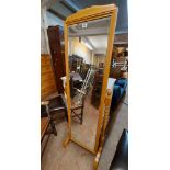 A modern stained mixed wood cheval mirror, set on flanking barley twist supports - sold with a