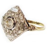 A marked 18ct 1920's design curved square panel ring with open collar set central diamond within a