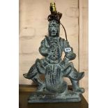 A large ceramic table lamp depicting an Oriental warrior figure with antiqued patina finish