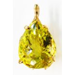 A 750 (18ct.) gold pendant, set with a large pear cut lime quartz stone - boxed
