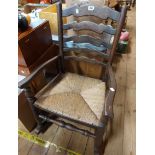 A varnished elm framed Lancashire ladder back rocking chair with woven rush seat panel, set on