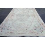 A handmade flat weave carpet with floral motifs on cream ground - 3.75m X 2.75m - grubby