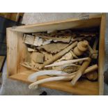 A pine linen chest (no lid) containing a quantity of assorted furniture parts including carved