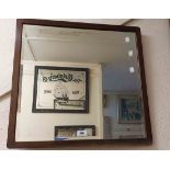 An oak framed bevelled square wall mirror