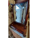 A Victorian mahogany platform dressing table mirror with oblong plate, set on break front base