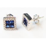 A pair of 750 (18ct.) white gold square panel stud earrings, each set with four central paved