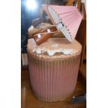 A vintage Lloyd Loom linen basket with original pink and gold painted finish and horsehair