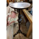 A Victorian mahogany jardiniere stand with turned and faceted pillar, set on a scroll tripod base