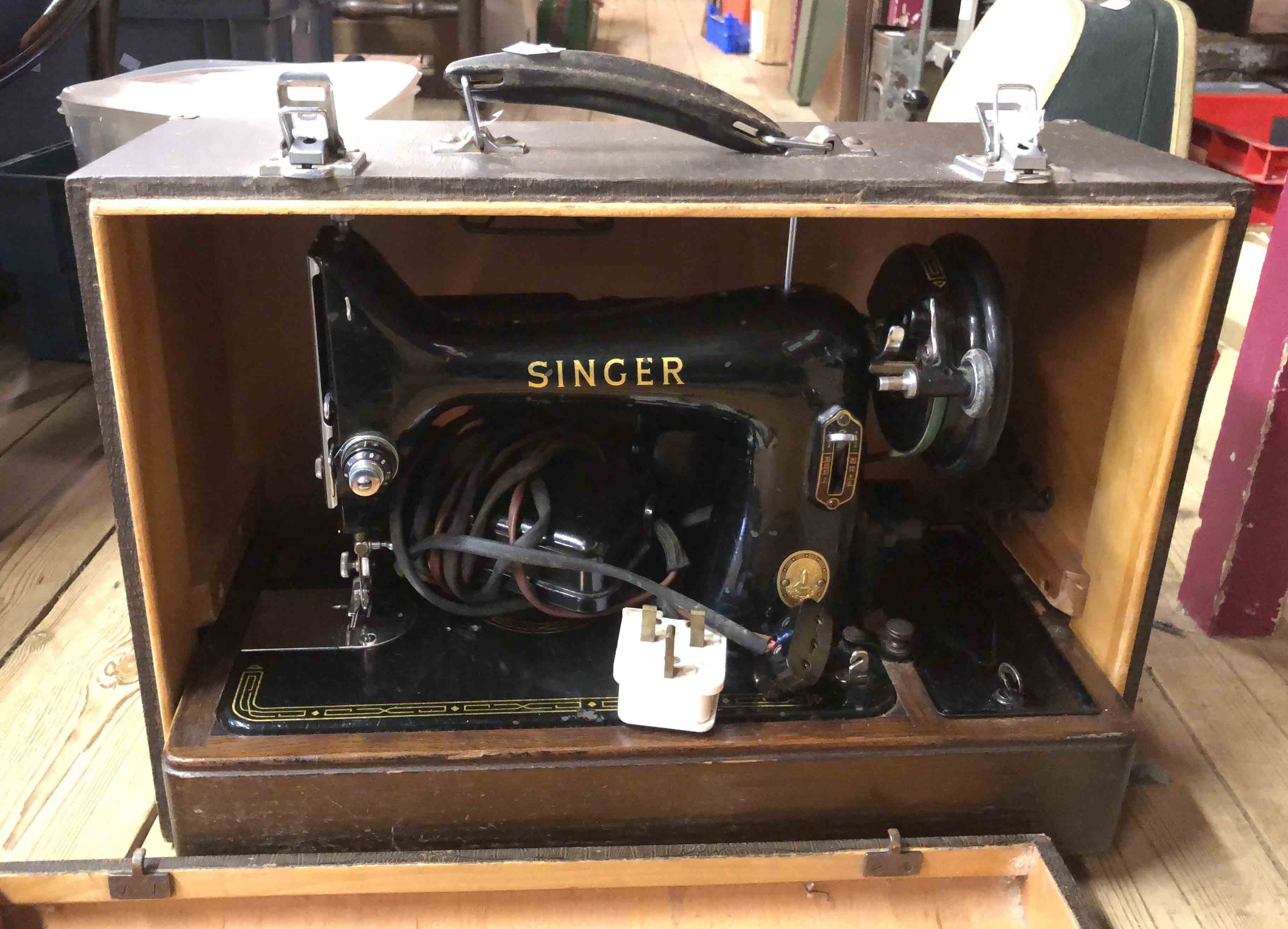 A Singer electric sewing machine in faux snakeskin effect hard case