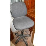 A modern swivel office chair with adjustable pillar and five star base, set on casters