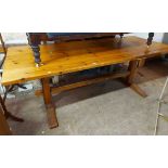 A 2.1m varnished pine refectory style dining table - sold with a long bench seat to match