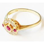 A 585 (14ct.) 1920's style gold ring, with three collar set rubies and ten small brilliant cut