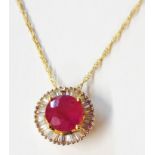 A marked 18k yellow metal pendant necklace, set with central round cut ruby within a baguette