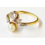 A marked 18ct yellow metal crossover ring, with collar set round cut diamond and pearl with