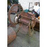 An old Dening & Co, Chard No. 3 heavy iron hand operated apple crusher, set on a wrought iron base -