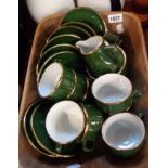 A basket containing a green glazed French part coffee set