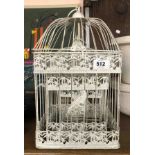 A modern set of three graduated painted metal birdcages