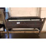 An old portable piano for restoration - sold with an old wooden dolls bed