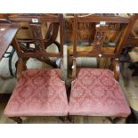 A pair of Edwardian walnut framed standard chairs with old rose floral cut velour upholstered seats,