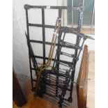 A late Victorian black painted iron and brass mounted cot with shaped side rails and lattice base,