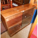 A mixed wood book cabinet with two shelves enclosed by glazed doors