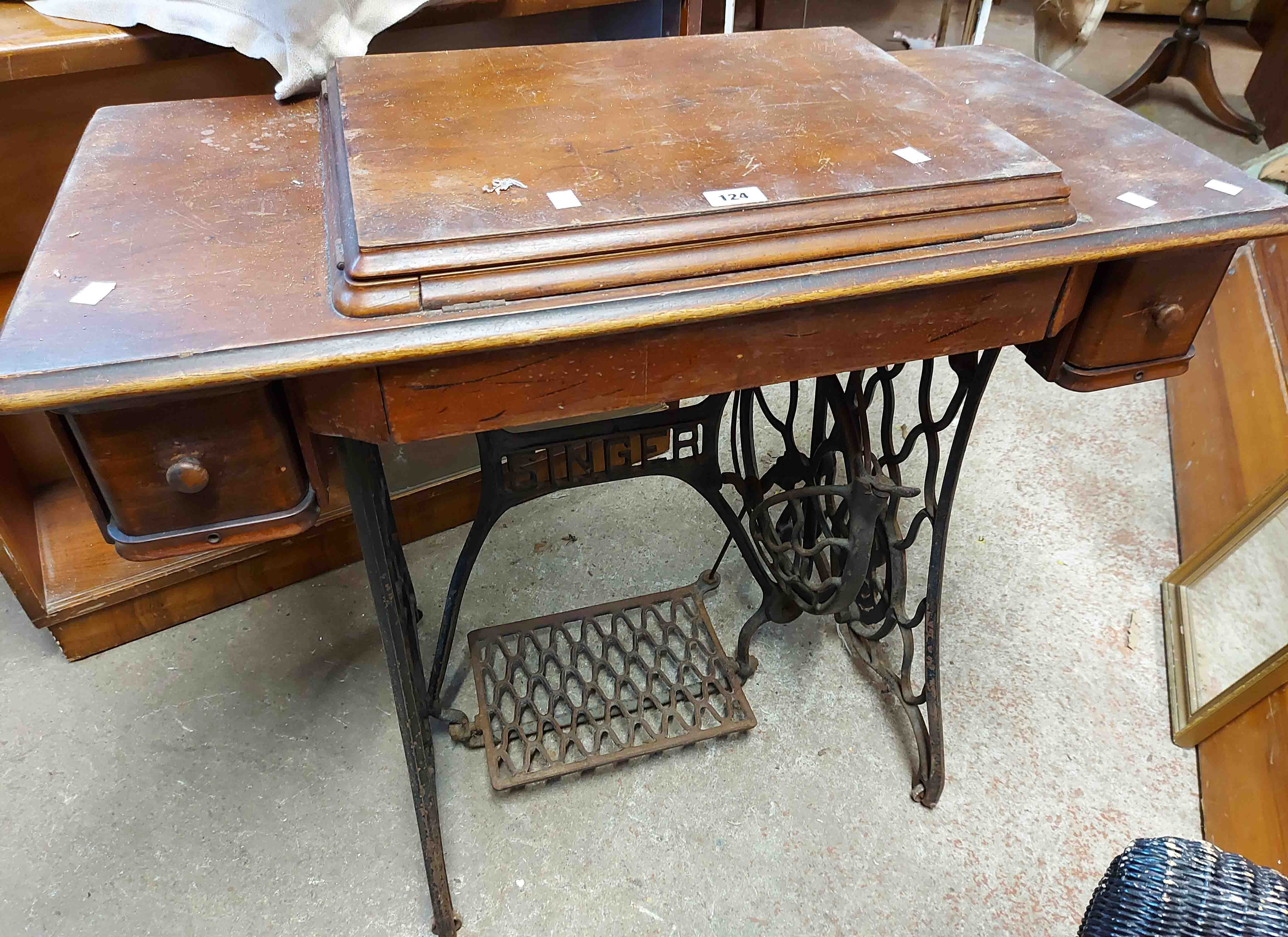 An old Singer treadle sewing machine, set on a decorative cast iron base