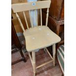 A modern Windsor style painted wood tall chair with stick back and turned supports