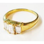 A marked 18K yellow metal ring, set with three baguette diamonds - 0.68ct. TDW - size K 1/2