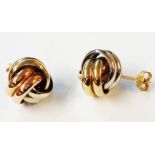 A pair of 9ct. three colour gold knot pattern stud earrings